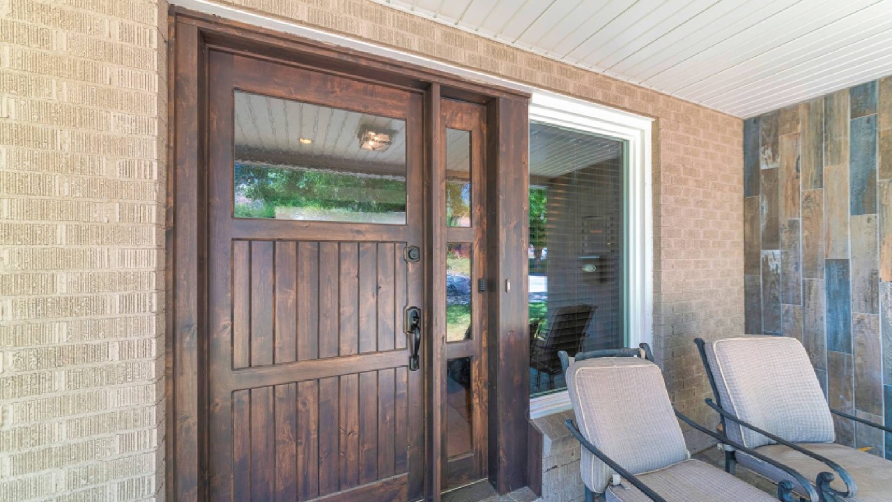 A wooden front door with a sidelight and picture window near Novato, California (CA)